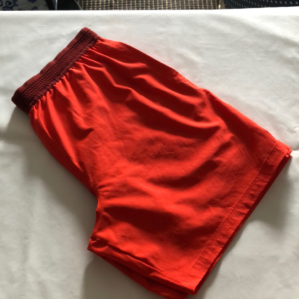 Men’s orange running shorts with compression shorts under two-in-one